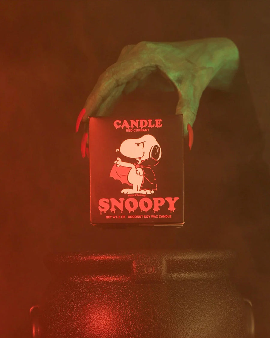 'witch' hand holding red currant scented candle with dracula snoopy