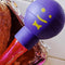 up close of pink acrylic baster with purple and yellow smiley squeeze top