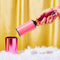 model holding hot pink metallic lint roller and green smiley top