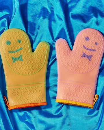 set of 2 orange and pink silicone oven mitts with smiley face detail