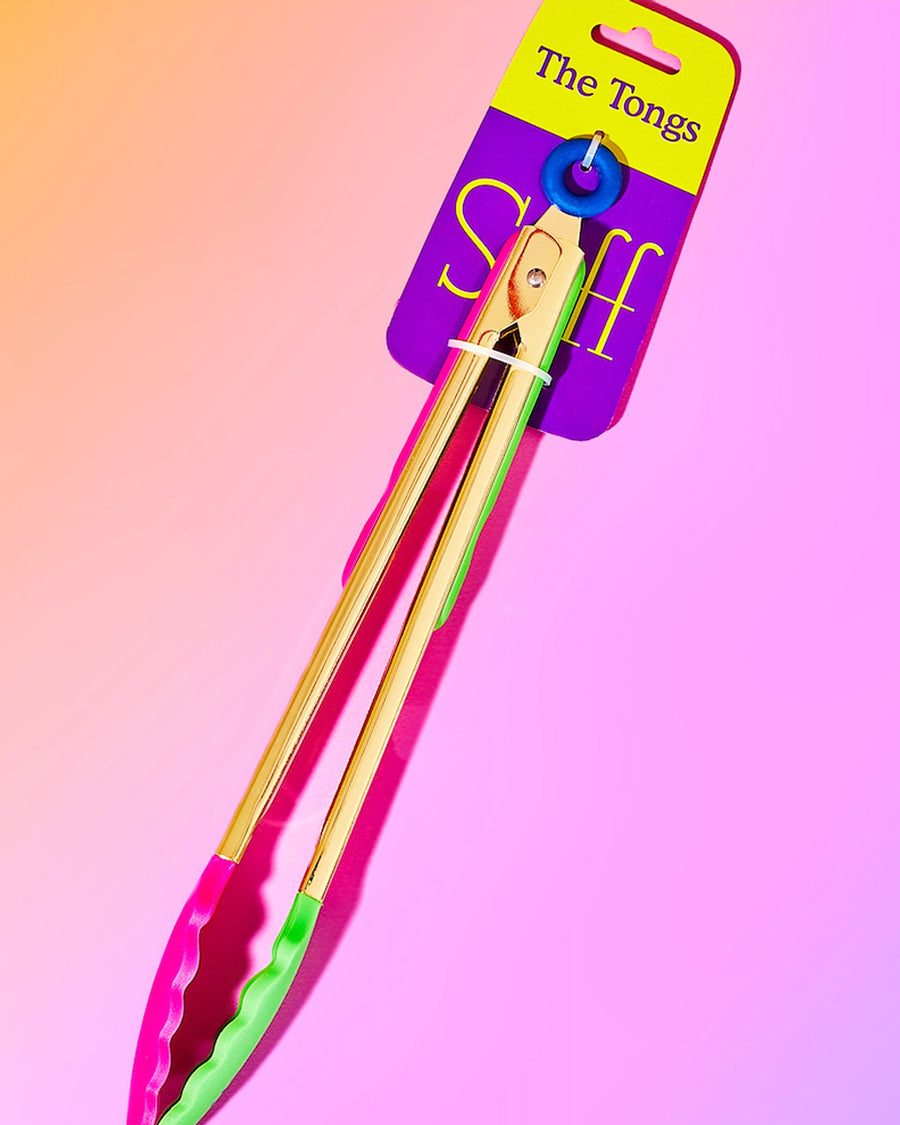 packaged gold tongs with pink and green silicone bottoms