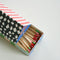 top view of colorful tip matches in a colorful house shaped box