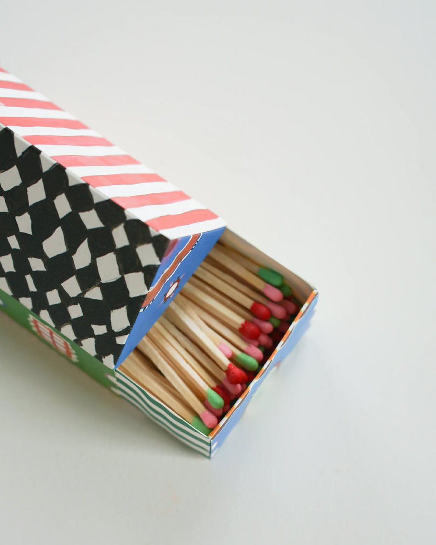 top view of colorful tip matches in a colorful house shaped box