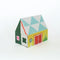 side view of colorful tipped matches in a colorful house shaped box