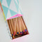 top view of colorful tipped matches in a colorful house shaped box