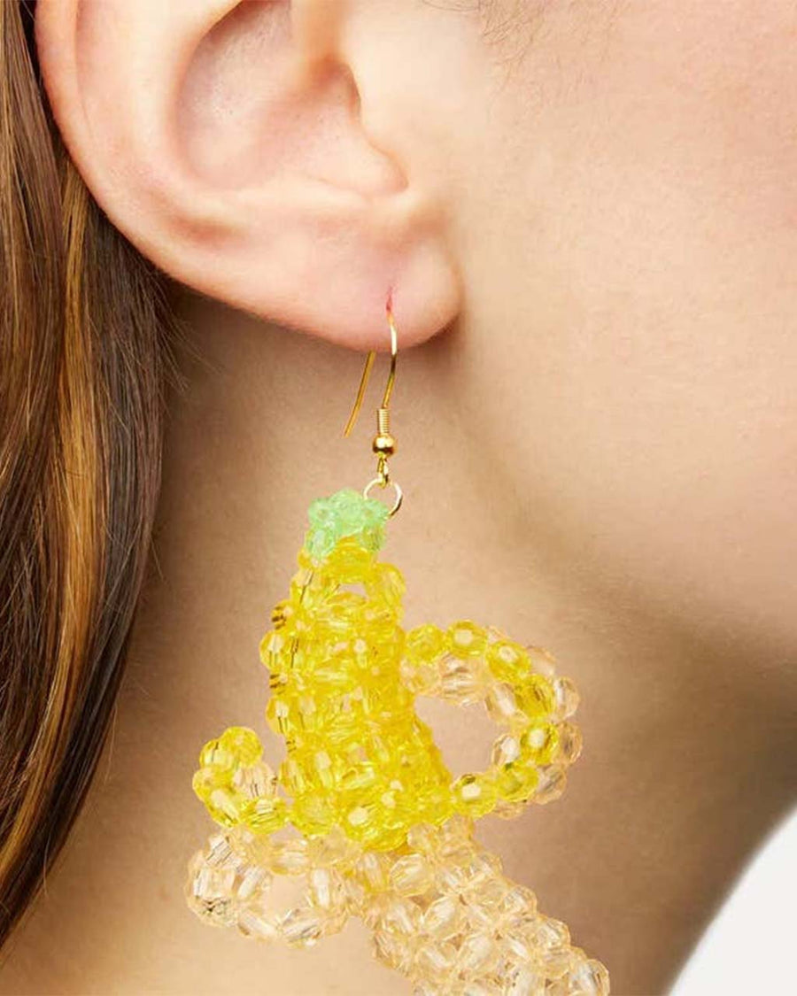 model wearing beaded banana dangle earrings