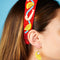 model wearing red beaded headband with beaded shrimp and lemon slices