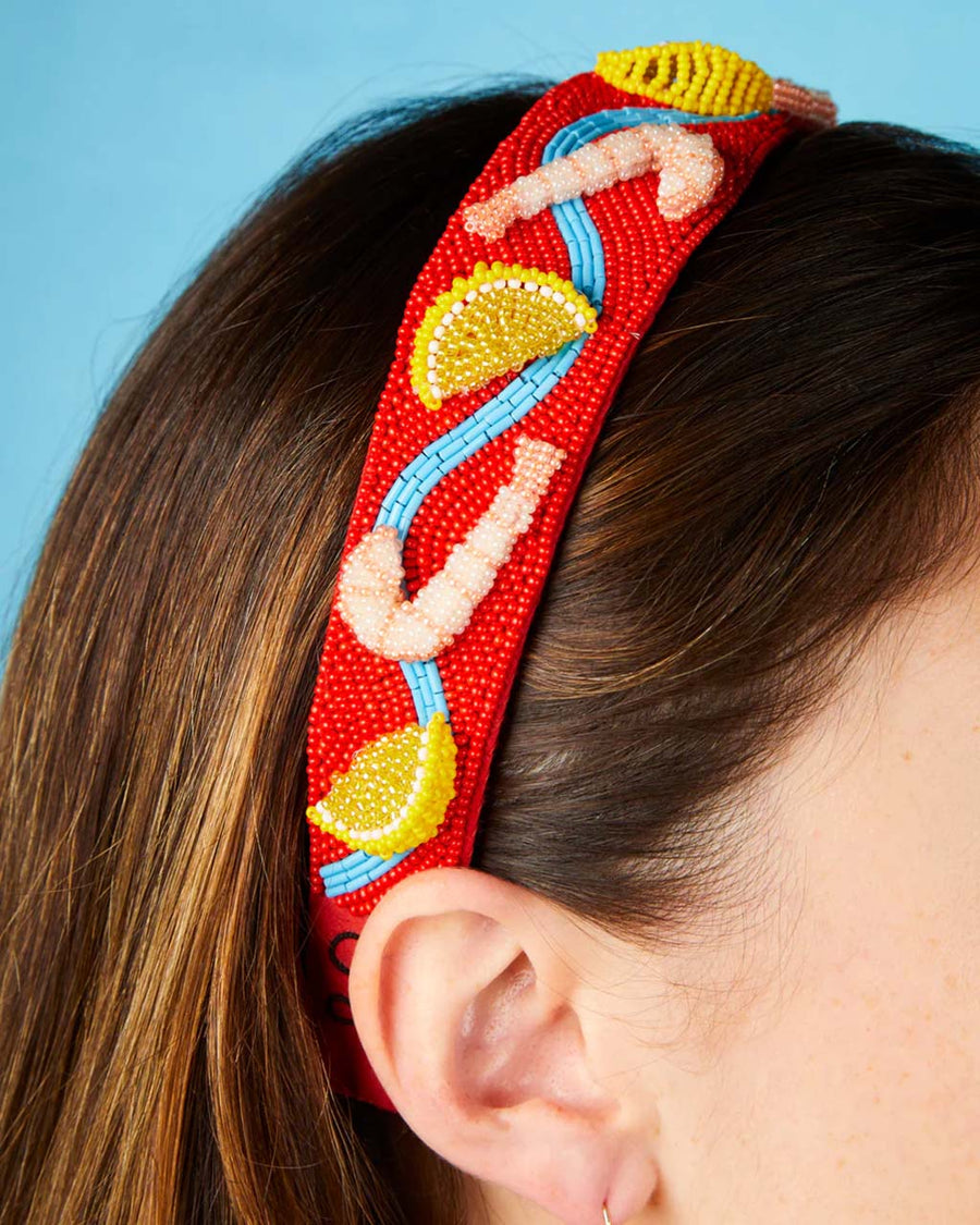 model wearing red beaded headband with beaded shrimp and lemon slices