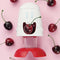 cherry chomper cherry pitter with cartoon face and surrounded by cherries