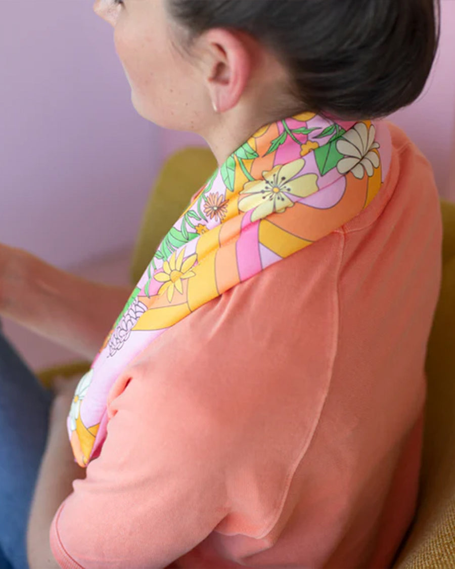 side view of neck wrap with a groovy pink floral print