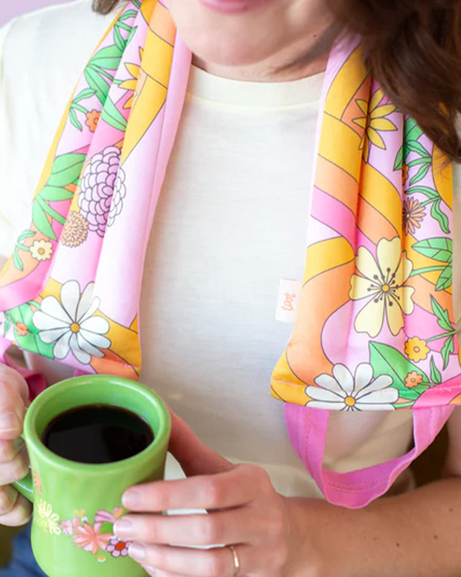 model wearing neck wrap with a groovy pink floral print