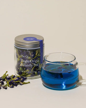 jar of single origin butterfly pea tea with brewed cup next to it