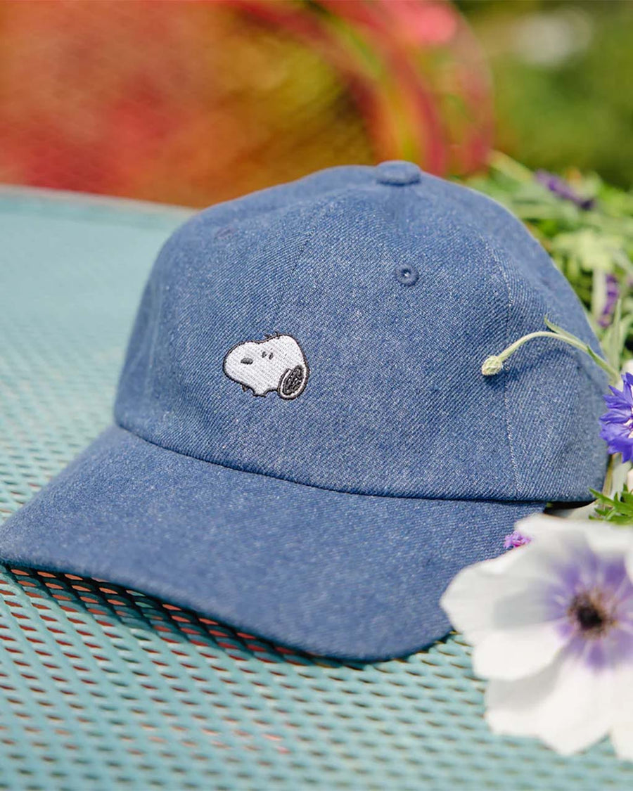 up close of denim dad hat with embroidered snoopy head patch