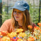 model wearing denim dad hat with embroidered snoopy head patch