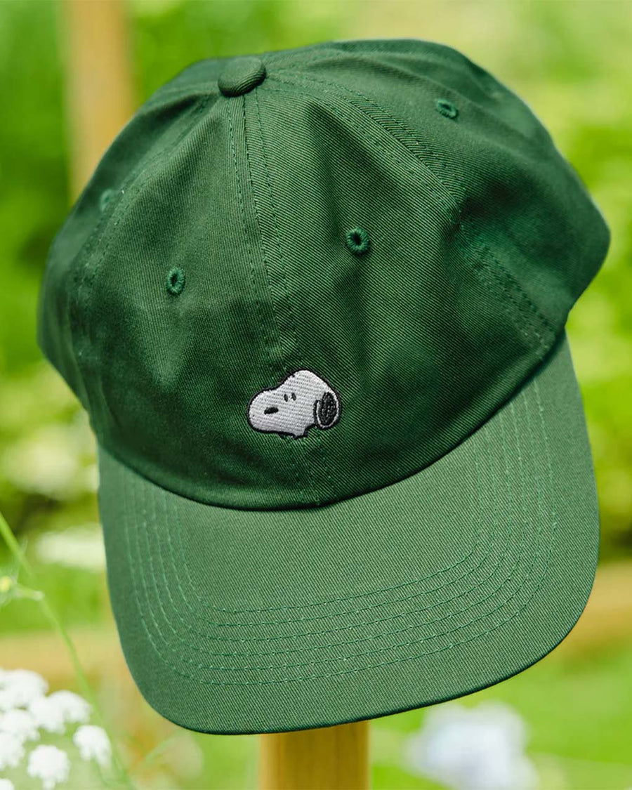 up close of forest green hat with embroidered snoopy face