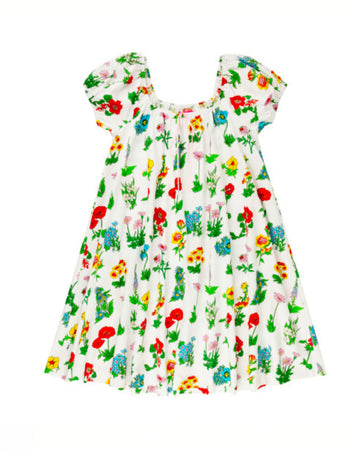 white mini dress with flowy skirt and colorful floral print
