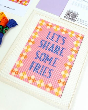 side view of 'let's share some fries' needlepoint kit with embroidery yarn and instructions