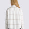 back view of model wearing white oxford style long sleeve shirt with maroon grid plaid