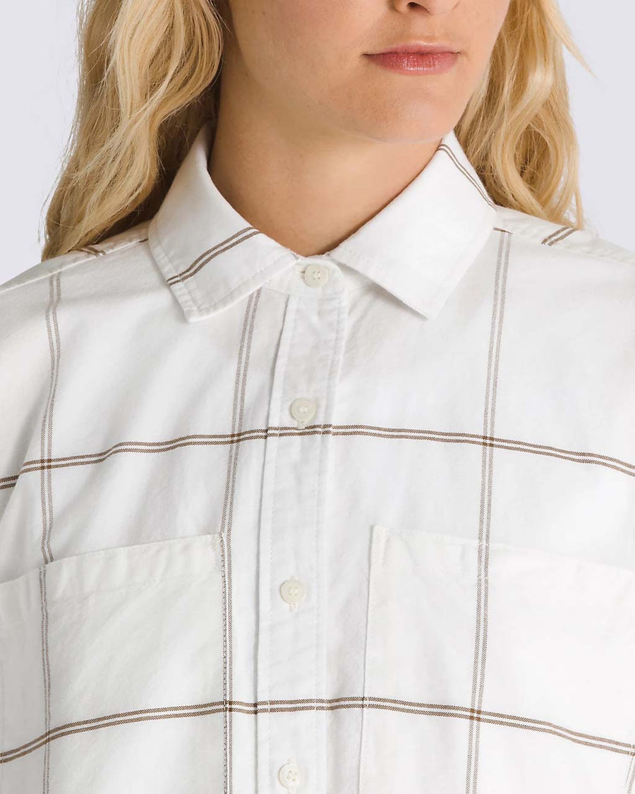 up close of model wearing white oxford style long sleeve shirt with maroon grid plaid