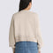 back view of model wearing oatmeal cropped cardigan sweater with balloon sleeves