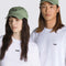 models wearing sage green cotton baseball cap with black vans embroidered logo