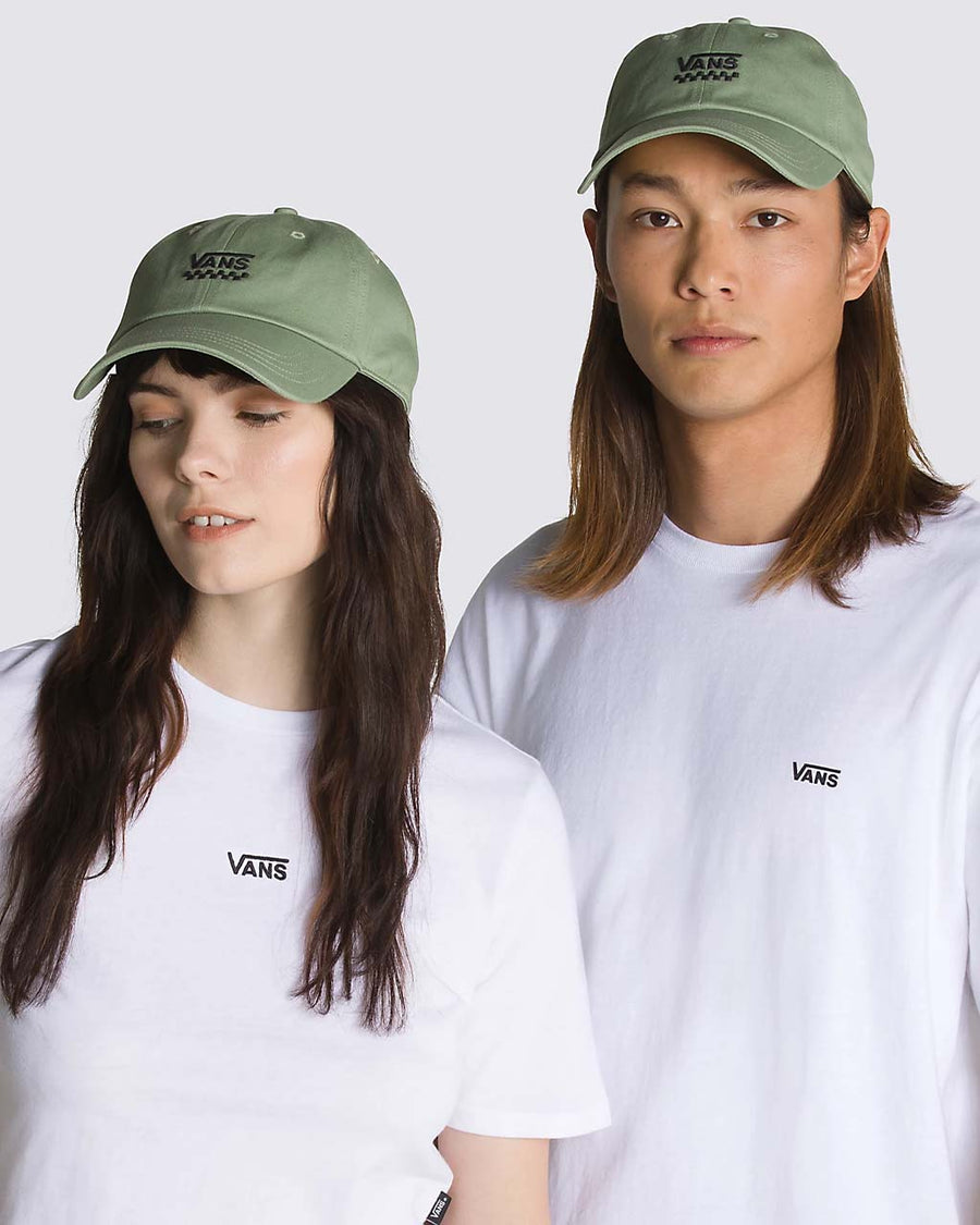 models wearing sage green cotton baseball cap with black vans embroidered logo