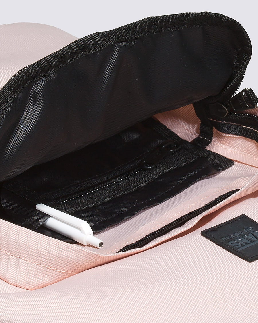 inside pocket of light pink backpack with black trim accents