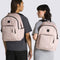 models wearing light pink backpack with black trim accents