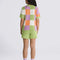 back view of model wearing green, purple, orange, and white checkered button front sweater top