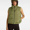 model wearing green puffer vest with high neck and side pockets