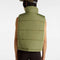 back view of model wearing green puffer vest with high neck and side pockets