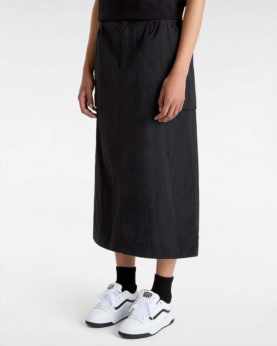 model wearing black midi skirt with elastic waist, button front, and cargo pockets