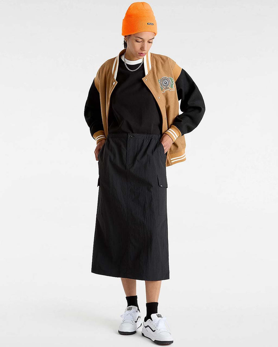 model wearing black midi skirt with elastic waist, button front, and cargo pockets