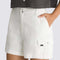 side view of model wearing white 3.5 inch inseam cargo shorts