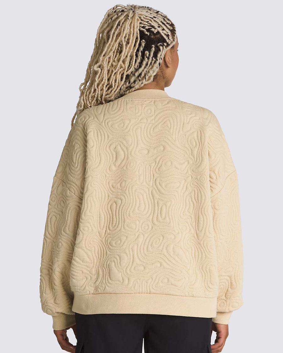 back view of model wearing sand long sleeve top with embroidered mojave desert jacquard