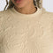 up close of model wearing sand long sleeve top with embroidered mojave desert jacquard