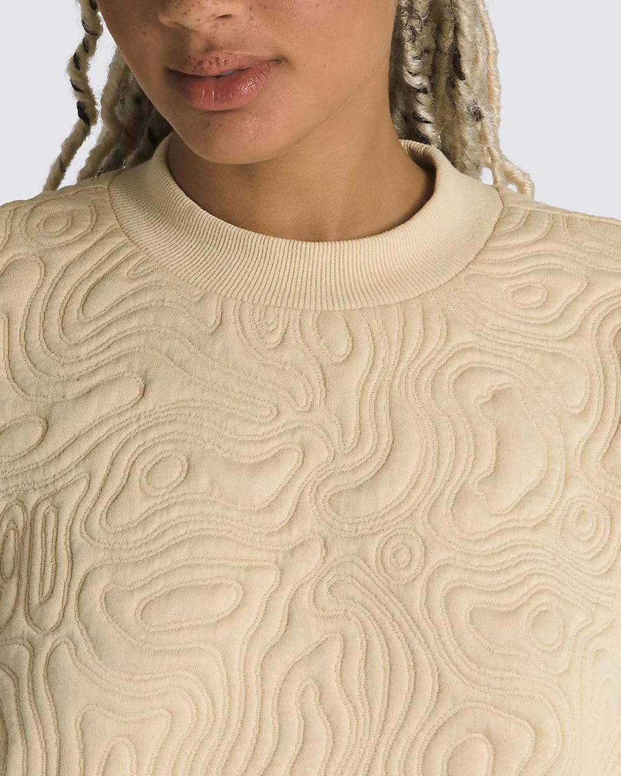 up close of model wearing sand long sleeve top with embroidered mojave desert jacquard