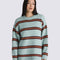 model wearing grey oversized sweater with burgundy and orange stripes