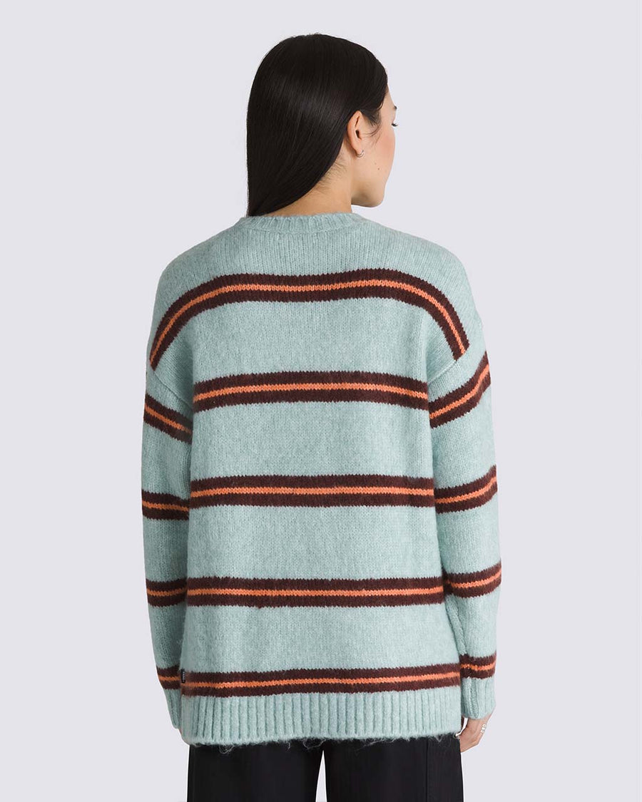 back view of model wearing grey oversized sweater with burgundy and orange stripes