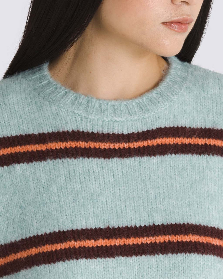 up close of model wearing grey oversized sweater with burgundy and orange stripes