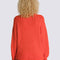 back view of model wearing red boucle relaxed fit cardigan