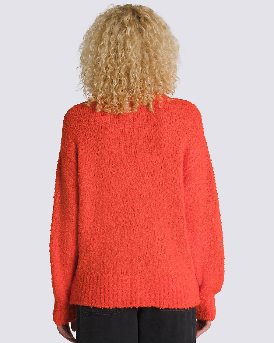 back view of model wearing red boucle relaxed fit cardigan