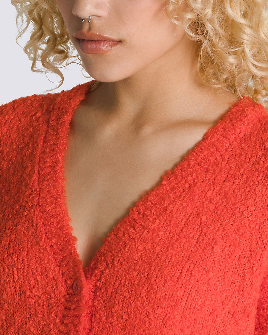 up close of model wearing red boucle relaxed fit cardigan