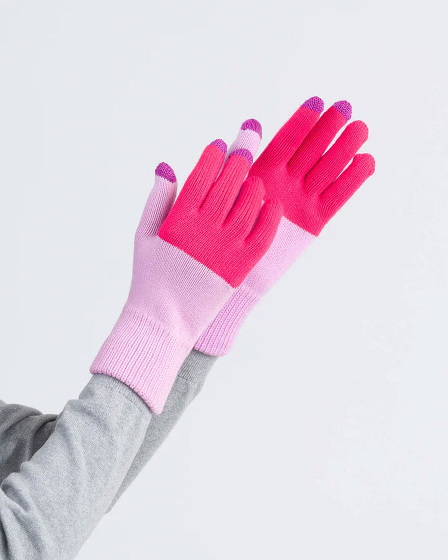 model wearing fuschia and lilac color block gloves with tech compatible fingertips