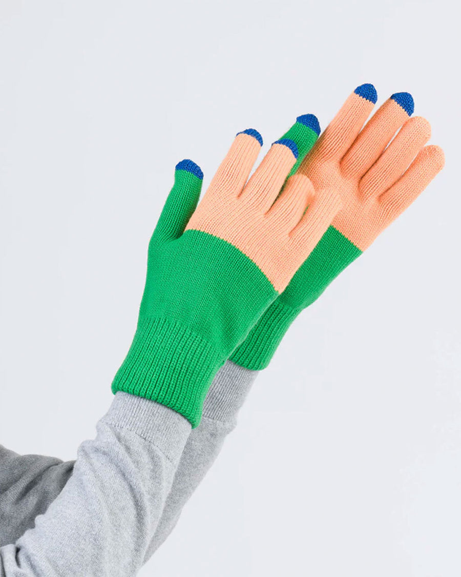 model wearing kelly and peach color block gloves with tech compatible fingertips