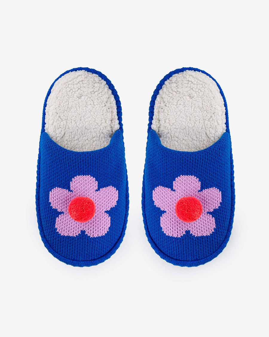 top view of blue slip on slippers with pink flower and pom detail and fuzzy interior