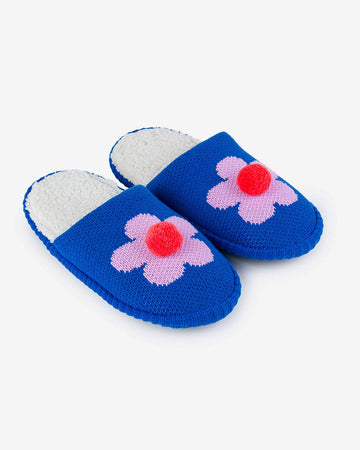 blue slip on slippers with pink flower and pom detail and fuzzy interior