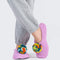 model wearing lilac knitted slip on slipper socks with rainbow pom with their legs crossed