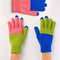 model wearing set of three pair of gloves in cobalt, coral and green colorblock