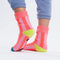 back view of pink striped socks with yellow and blue trim and non-slip bottom